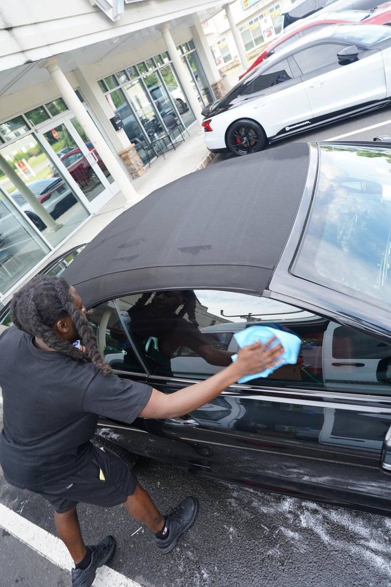 Xentra Auto technician detailing a vehicle on location in NYC